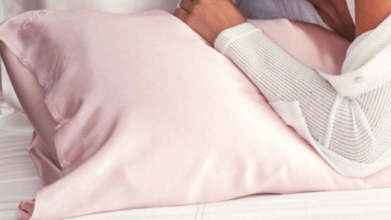 Woman leaning on a silk pillowcase