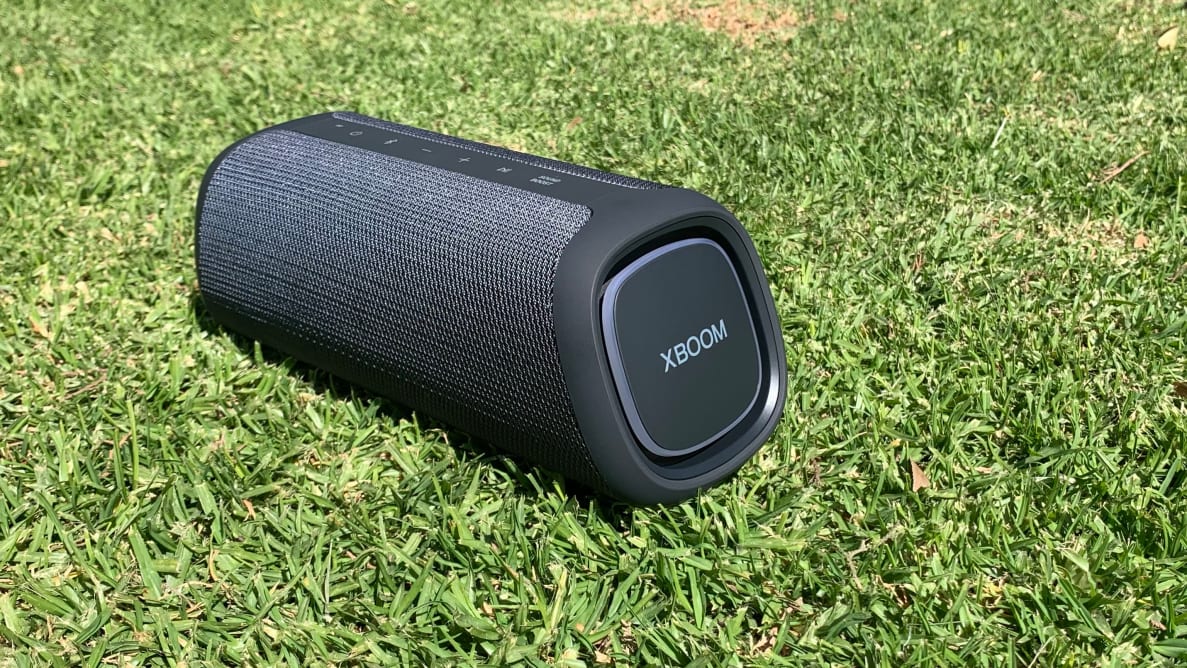 A black LG XBoom Go on a patch of grass.