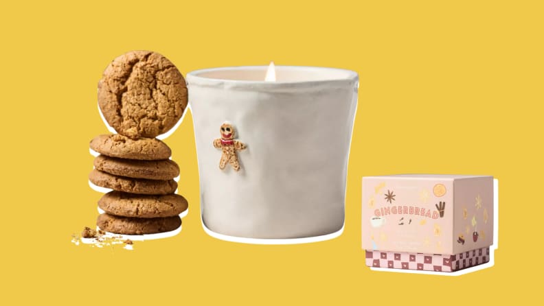 A ceramic candle with a gingerbread design, cookies, and a gift box, in a yellow background