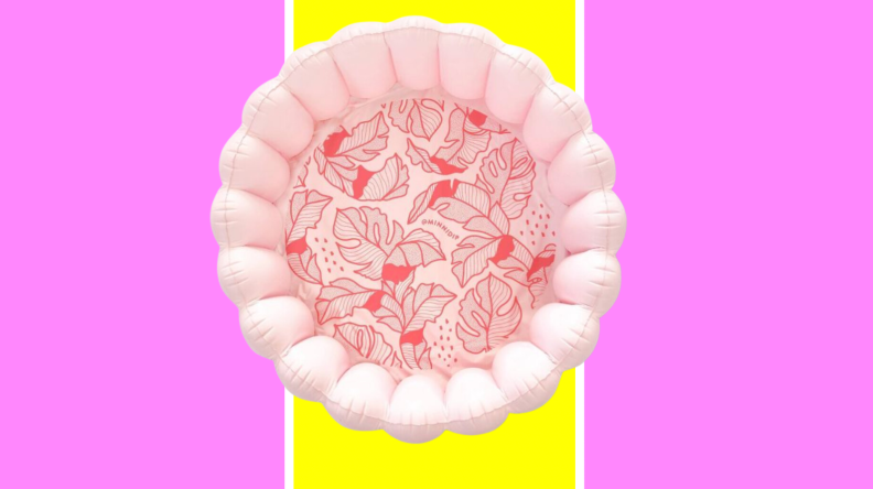 A pink, scalloped pool with red palms
