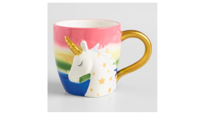 A coffee mug with a gold handle and an image of a unicorn.