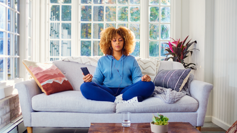 woman meditating on couch