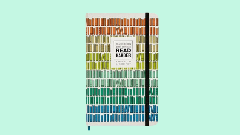 A colorful reading log journal on a green background.