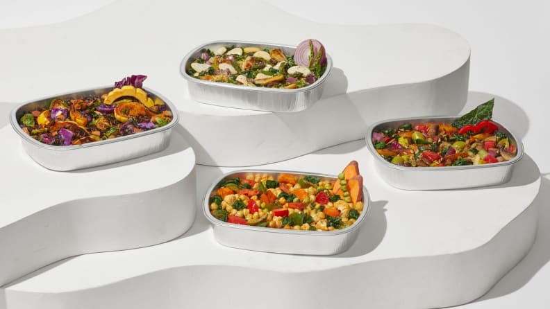 All four Daily Harvest Harvest Bakes spread on minimalist white steps