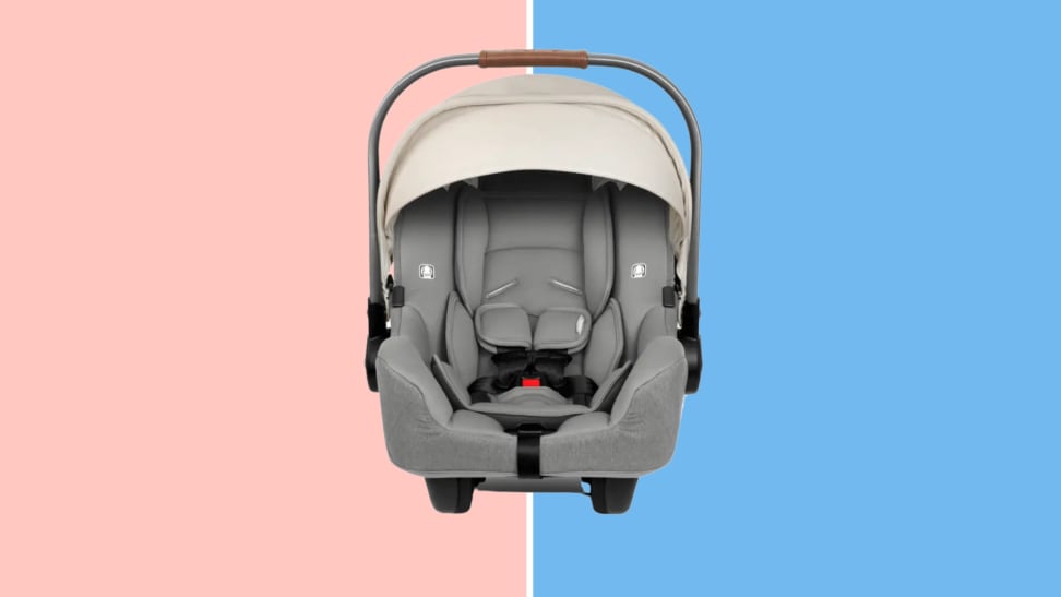The Nuna Pipa car seat in front of a pink and blue background.