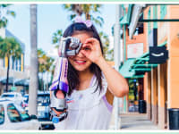 A young girl wears a bionic arm from Limbitless Solutions.