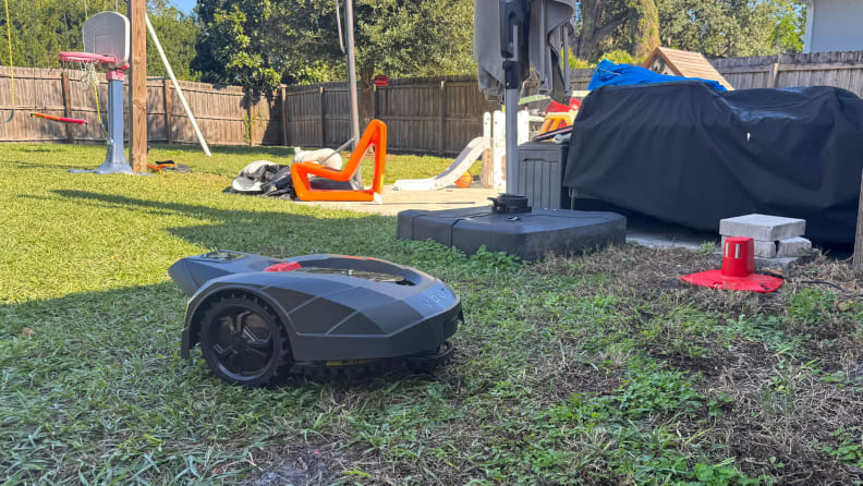 A black Volta robot lawn mower on grass