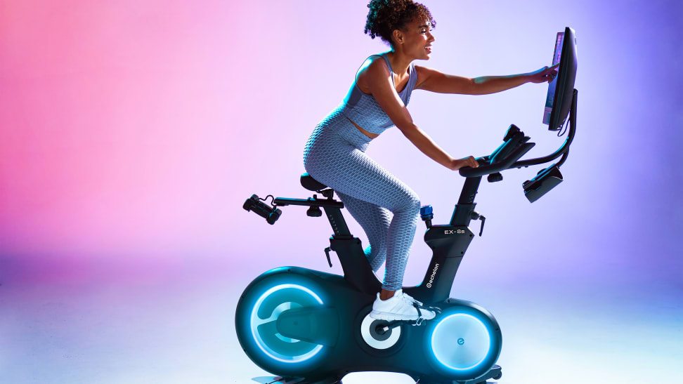 A woman riding an exercise bike.