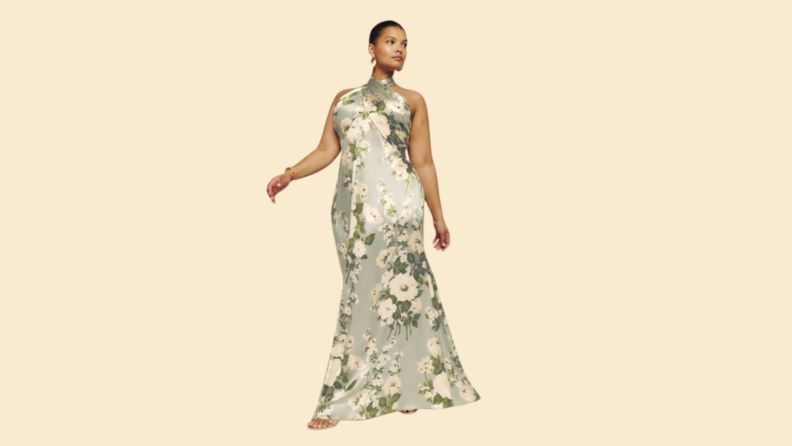 A model wearing a green floral printed gown.