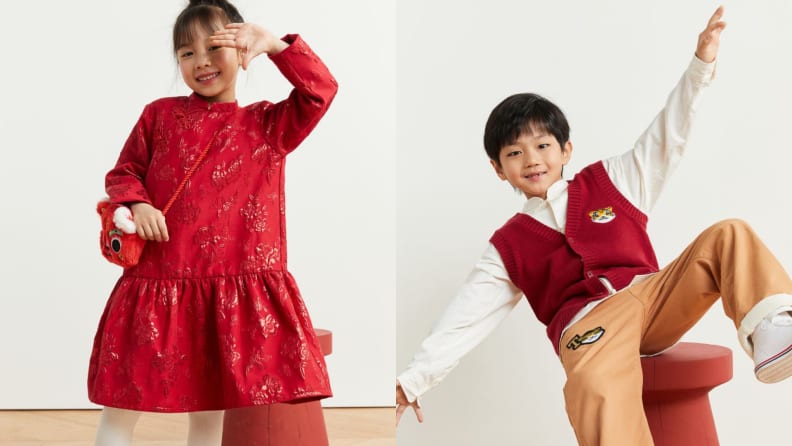 A girl in a red brocade dress and a boy in a red vest with an embroidered tiger