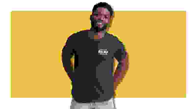 Person wearing a The Bear t-shirt on a yellow background