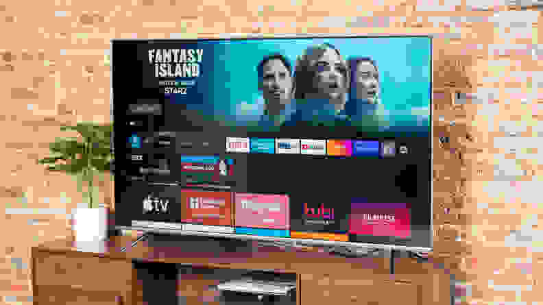 The Amazon Fire TV Omni displaying its smart platform's home screen in a living room setting