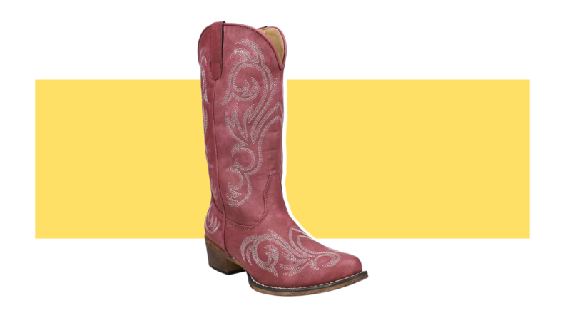 A red suede cowboy boot with white embroidery.