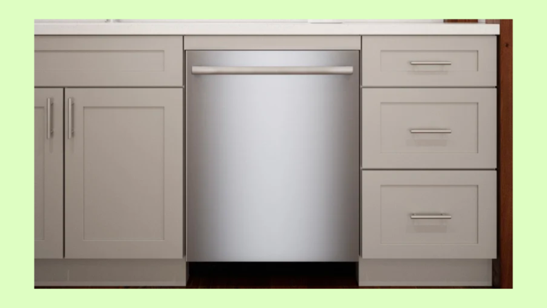 Bosch SGX78B55UC/13 stainless steel dishwasher in between white cabinets in kitchen setting.