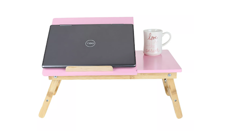 Pink Coolpad with laptop angled on it and coffee mug on the side.