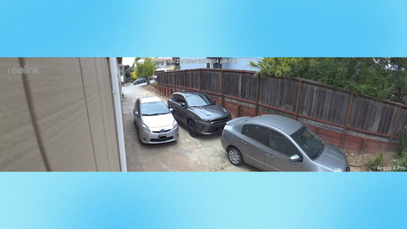 A picture of a residential driveway withe three cars in it taken on the Reolink Argus 4 Pro security cam.