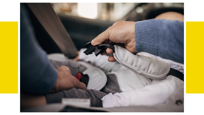 A parent's hand buckling a seatbelt on a child