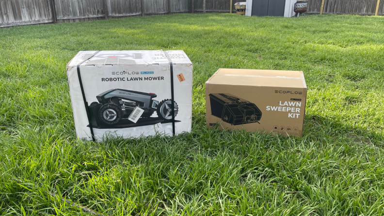 Two boxes on grassy lawn outdoors on a sunny day.