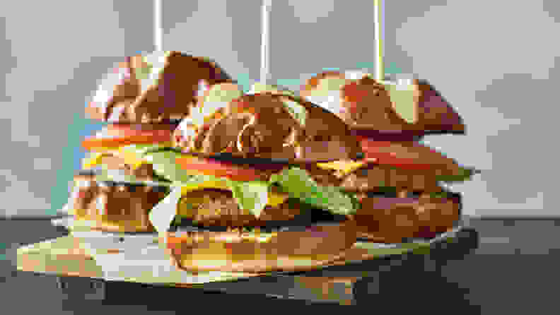 Three vegan burger sliders with pretzel buns
