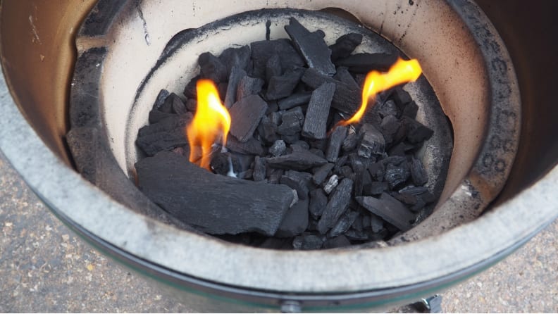 Hot coals with two flames sitting in a Big Green Egg.