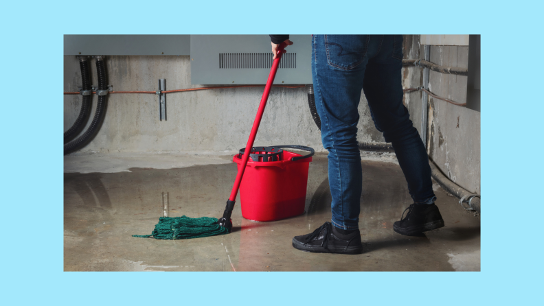 A person mopping up a basement floor.