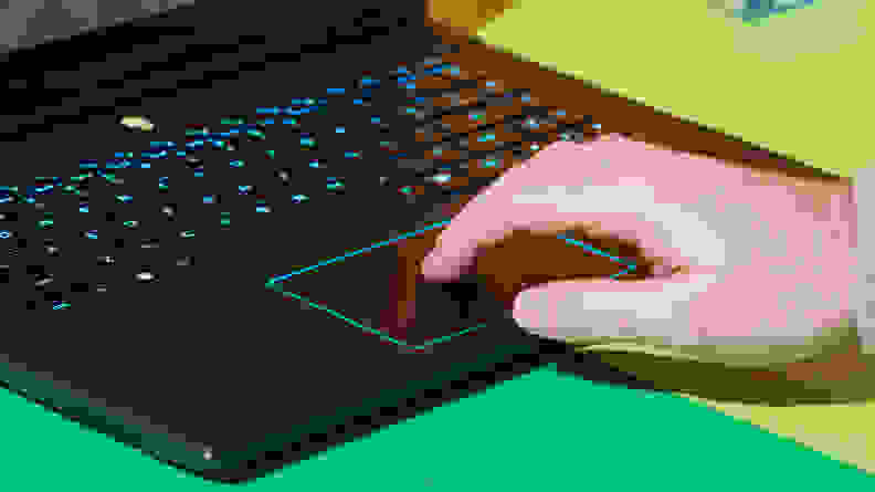 Person using fingers on the trackpad of the Alienware m16 R2 gaming laptop.