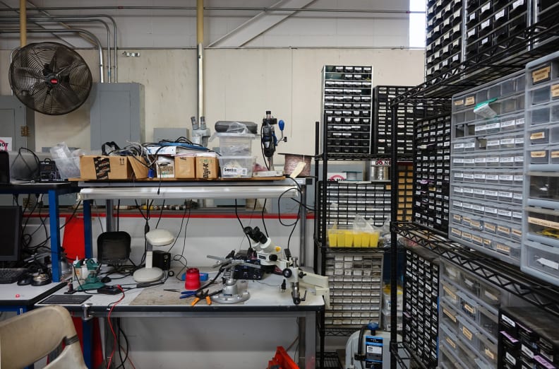A bench full of microscopes.