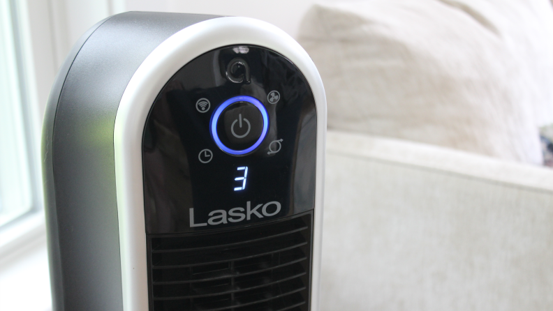 A close-up view of the black Lasko Aria Smart Tower fan's digital display showing that it is on the third fan speed setting.