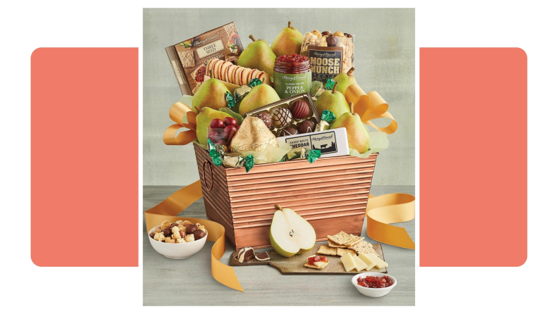A Harry & David gift basket filled with fruits, cookies, chocolates, nuts and other snacks.