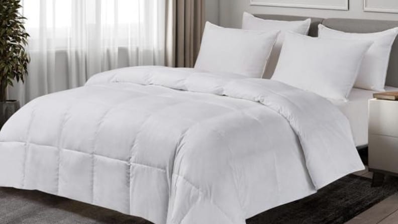 A bed made with a white comforter