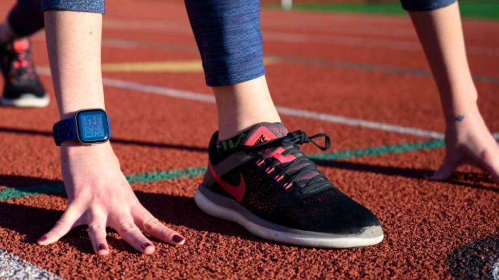 A woman wearing Nike running shoes on a track