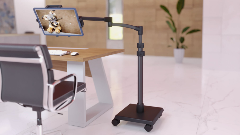 Tablet stand next to desk and chair.