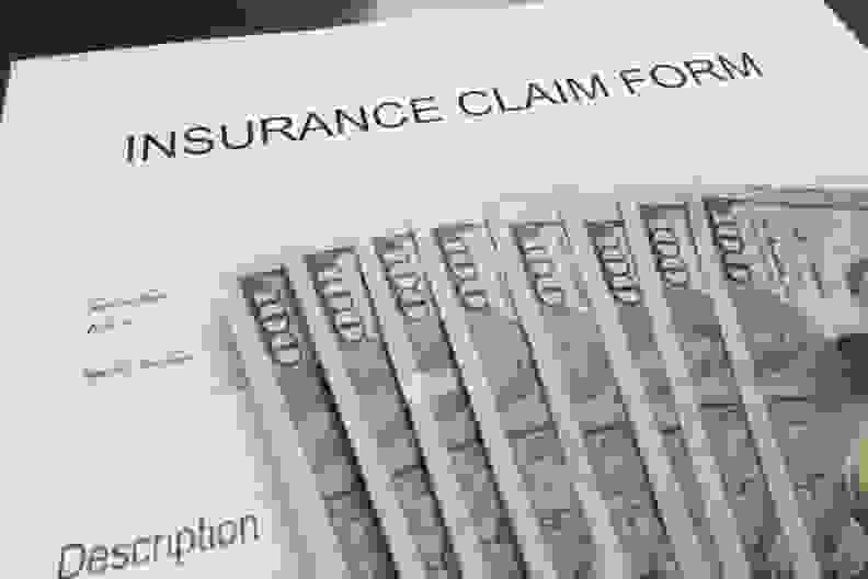 Insurance claim form and assorted money