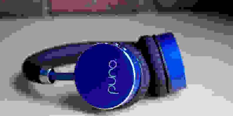 A pair of blue Puro BT2200 headphones lying on their side.