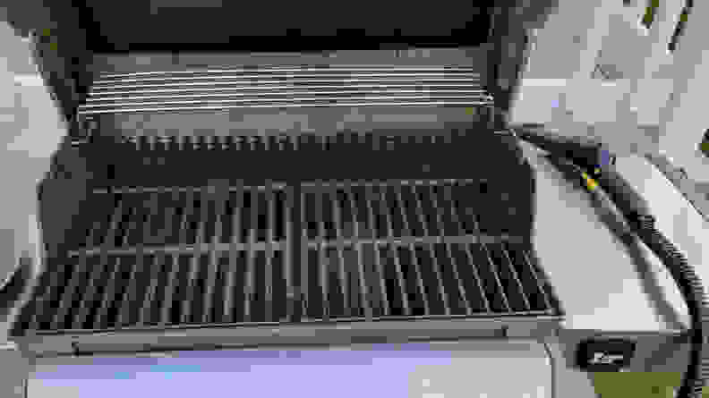 A recently cleaned gray grill with a black cooking surface.