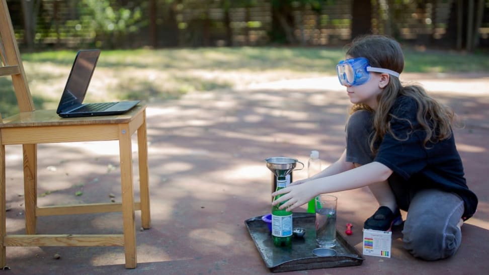 Girl doing science experiment outside