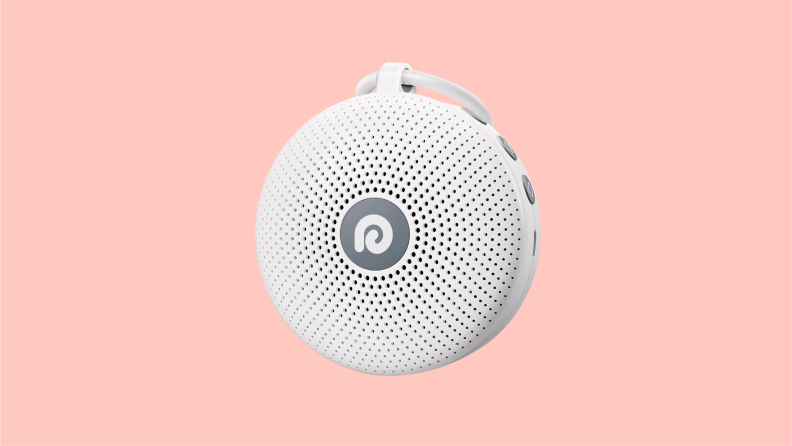 Front view of the Dreamegg white noise machine, an ovoid instrument with countless speaker openings radiating from the center.