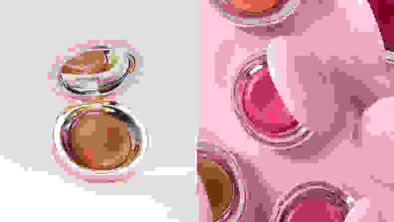On the left: The Rare Beauty by Selena Gomez Stay Vulnerable Melting Cream Blush on a cream background open to a reveal a pink cream blush. On the right: Multiple Rare Beauty cream blushes in their pink packaging sitting open on a pink background to show the different colors.