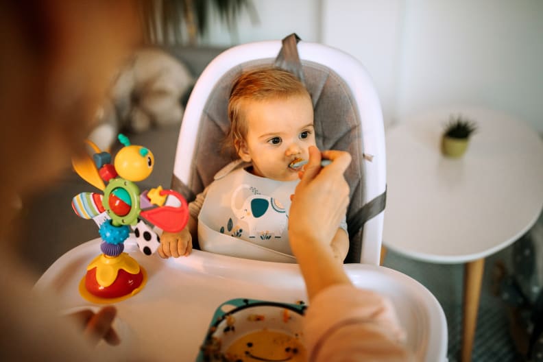Mother feeding her little baby boy