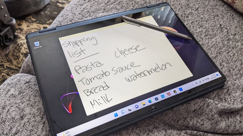 The Lenovo Yoga 6 in tablet form with a shopping list on its screen and a stylus resting on top of it.