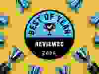 Reviewed Best of Year circular blue and black award badge sits on a yellow background surrounded by blue trophies