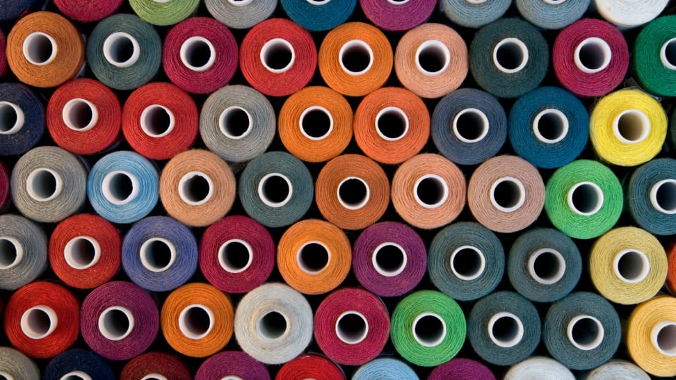 Stacks of multicolored bobbins of fabric.