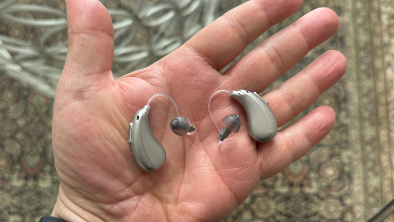 Elehear Beyond hearing aids sit in the palm of a hand