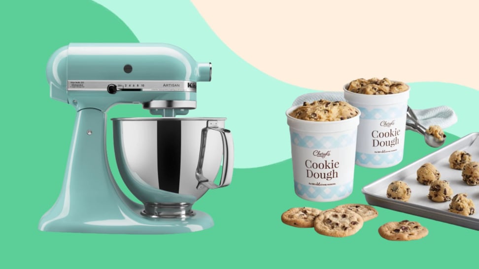 KitchenAid mixer, cookie dough tubs, and cookie sheet on a green background.