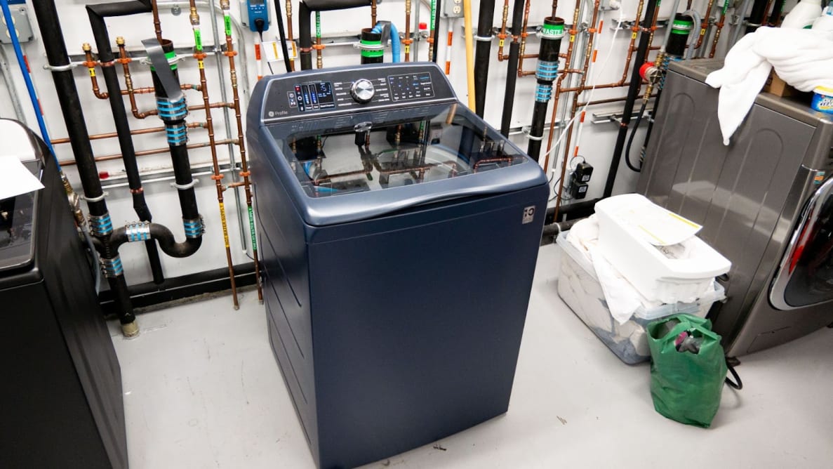Product shot of the navy colored GE Profile PTW900BPTRS Top-load Washing Machine inside of testing laboratory.