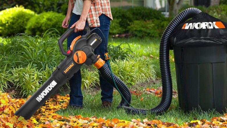 person blowing leaves with leaf blower