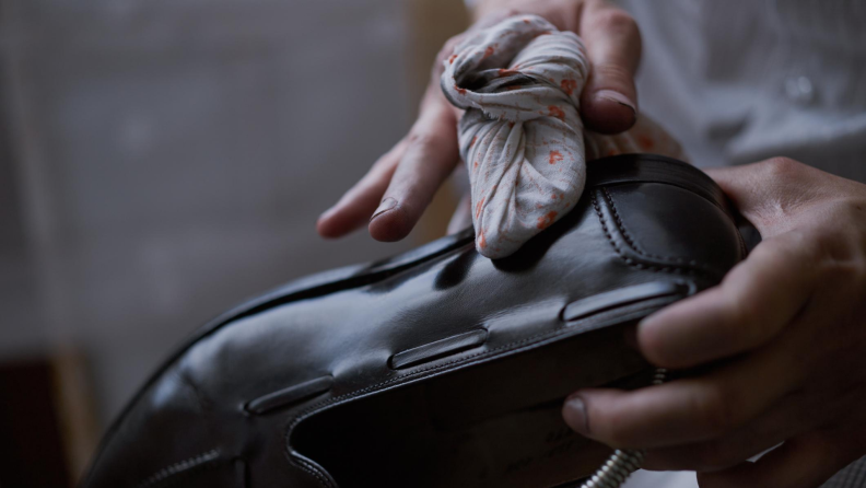 chamois cloth cleans a leather shoe