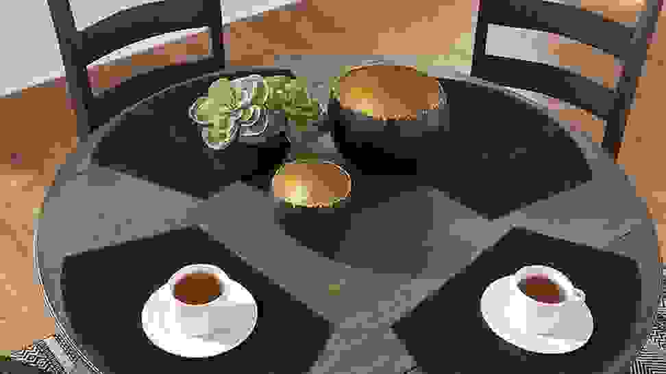 A set of four placemats placed on a round dining room table.