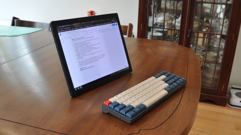 A detachable laptop sits on a desk