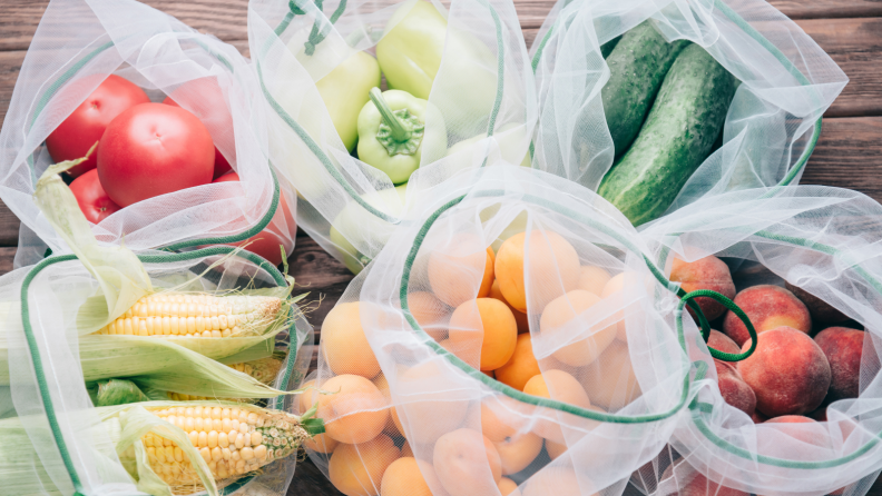 Mesh produce bags filled with fruits and vegetables.